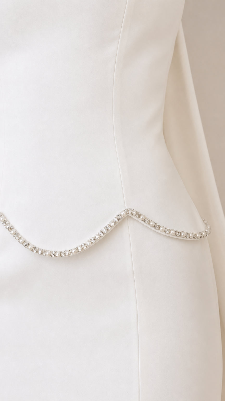 Close-up of sparkling rhinestone trim along the scalloped waistline