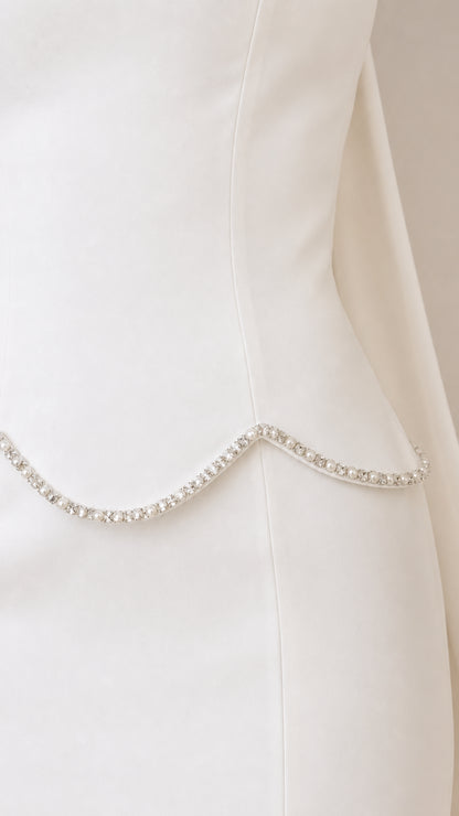 Close-up of sparkling rhinestone trim along the scalloped waistline