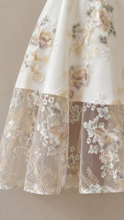 Close-up detail of sheer embroidered floral lace hem