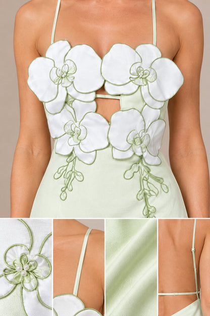 Close-up detail of 3D embroidered floral appliques and front cutout