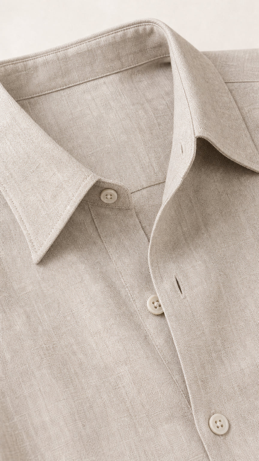 Close-up of beige linen-textured fabric, lapel collar, and button placket