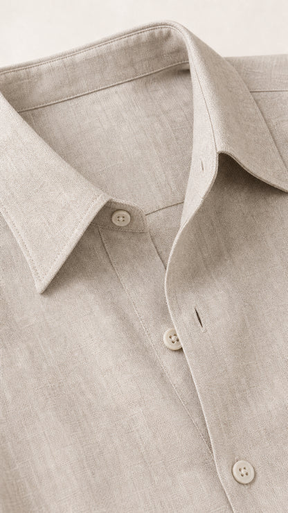 Close-up of beige linen-textured fabric, lapel collar, and button placket