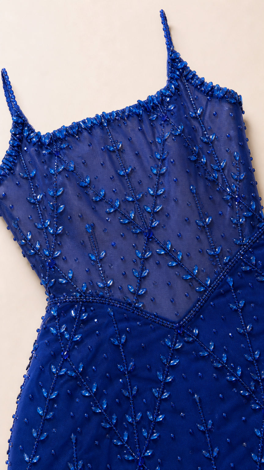Close-up detail of sheer corset bodice with intricate royal blue beading