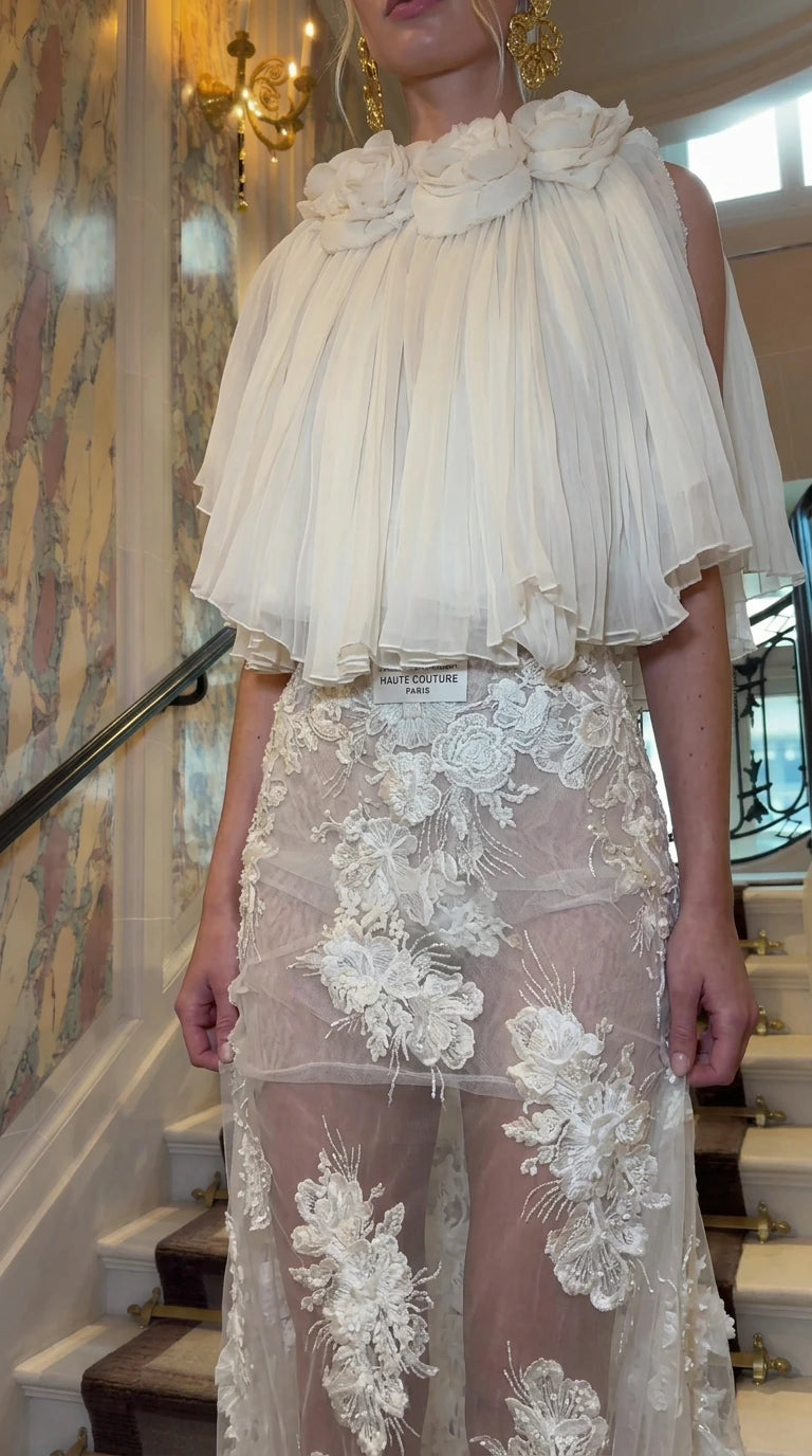 Close-up of pleated capelet neckline with 3D floral appliques and lace embroidery