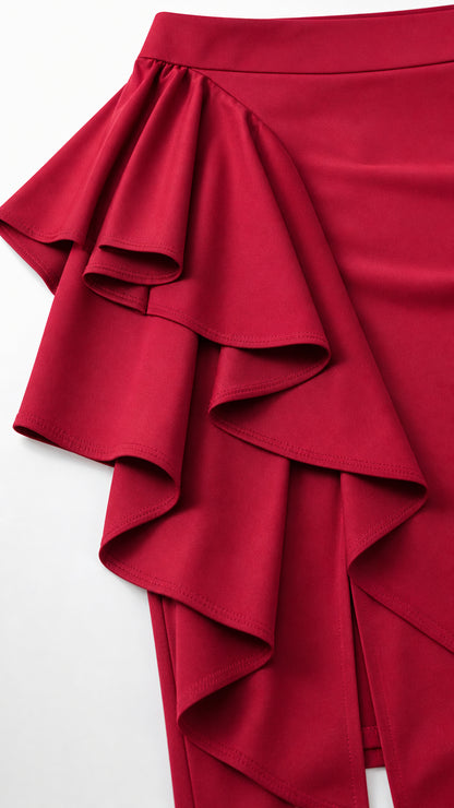 Close up view of red fabric and tiered cascading side ruffle detail on skirt