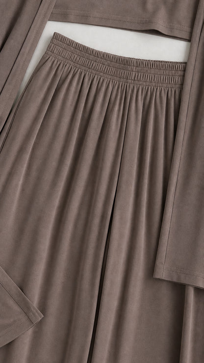 Close-up detail of the gathered elastic waistband, soft fabric texture, and sleeve cuff