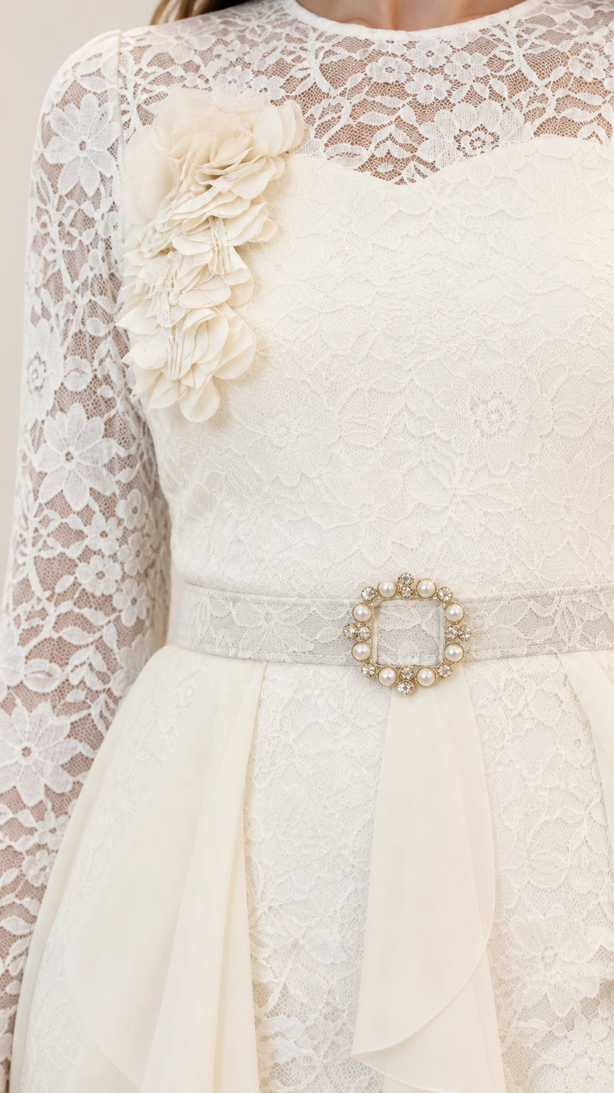 Close-up of off white floral lace bodice with 3D flower applique and jeweled belt buckle