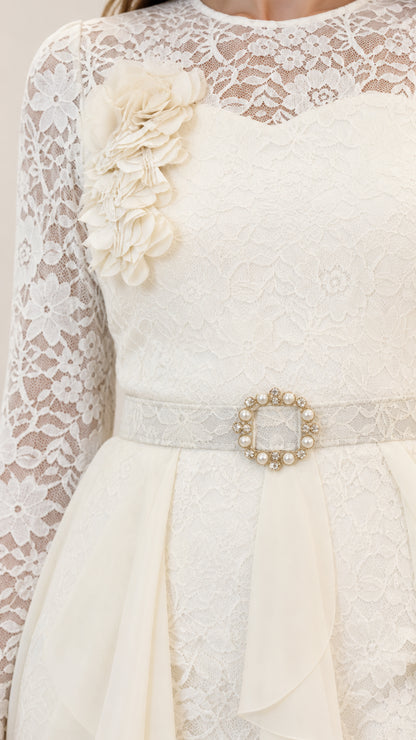 Close-up of off white floral lace bodice with 3D flower applique and jeweled belt buckle