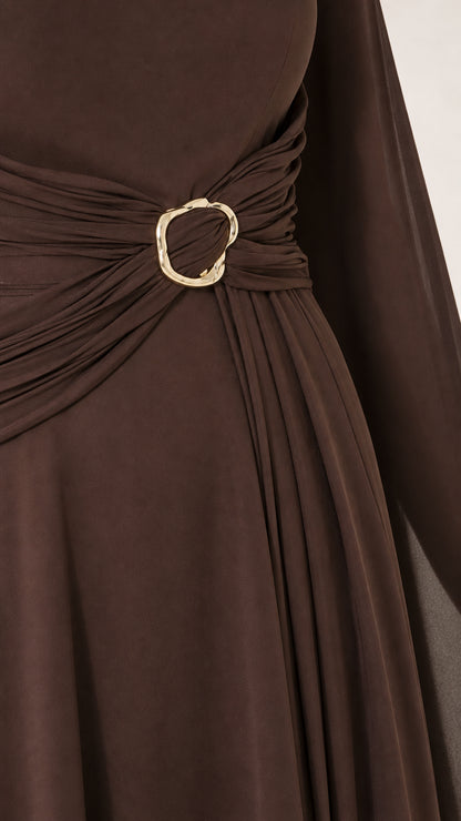 Close-up detail of side waist ruching and gold-tone circular buckle accent