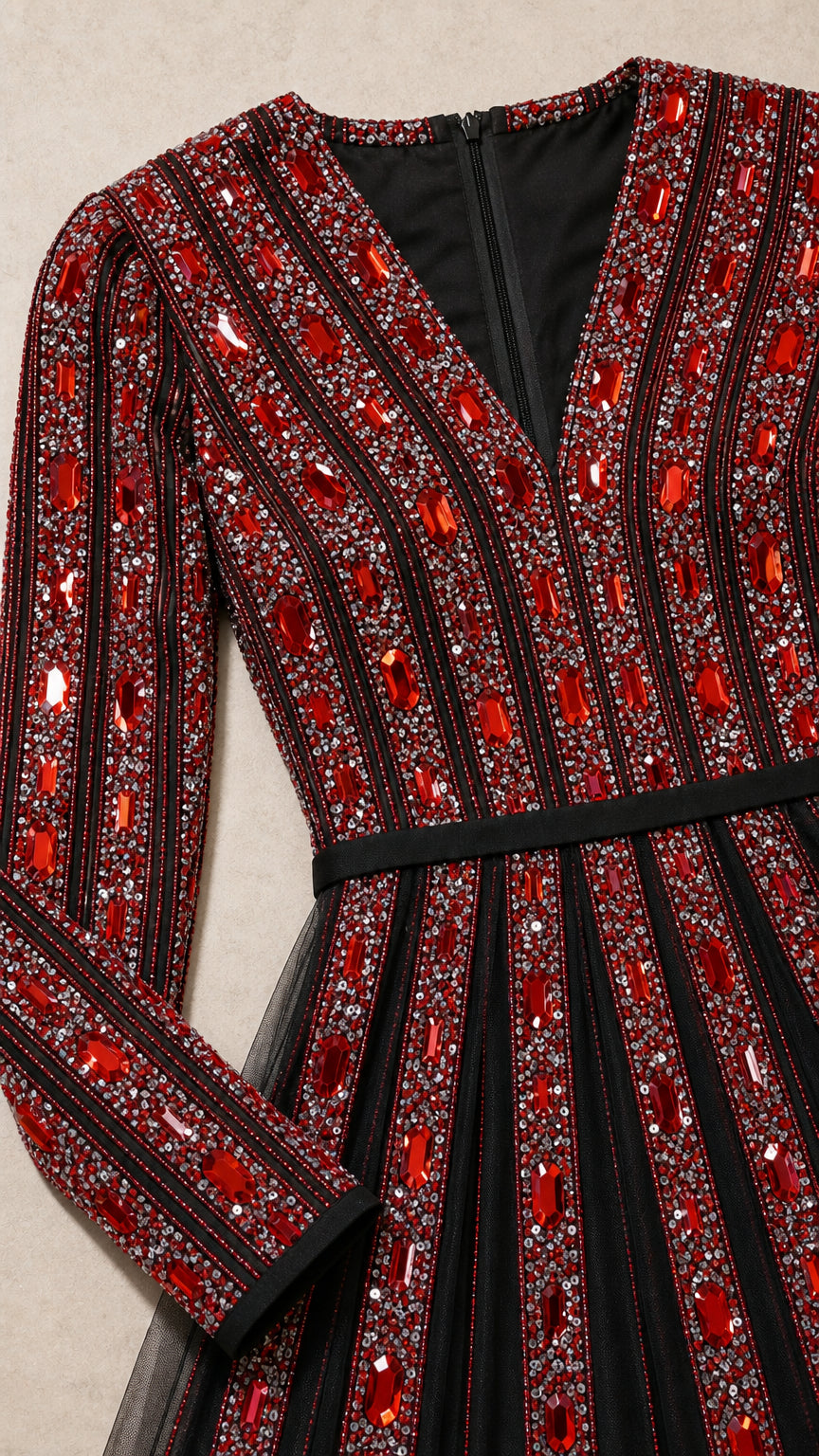 Close up detail of V-neckline and red rhinestone vertical embellishments on black tulle