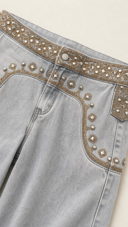 Close-up detail of metallic bead and rhinestone waistband embroidery