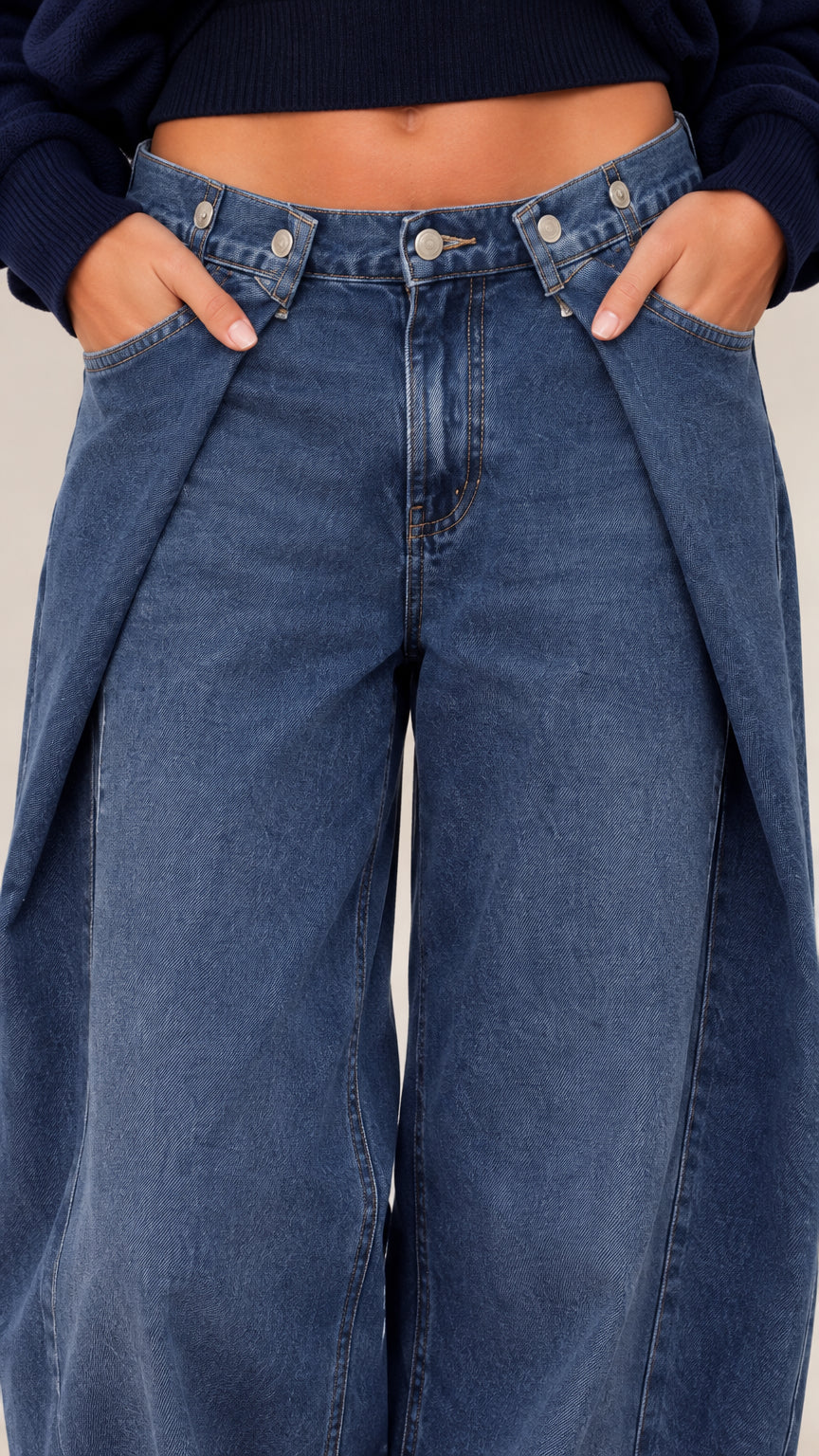 Close-up detail of waistband and denim styling with cropped knit hem