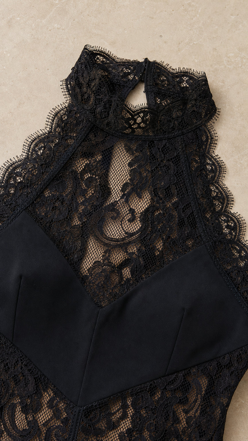 Close-up of black floral lace halter neckline and bodice