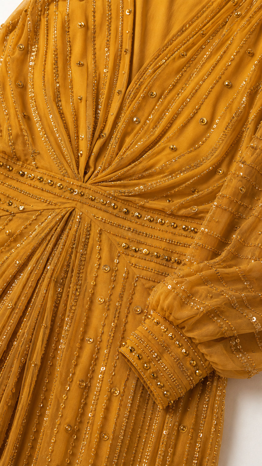 Close-up detail of bodice, neckline, and sleeve cuffs with bead embellishments