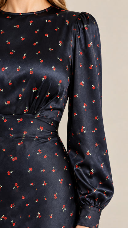 Close-up detail of bodice and bishop sleeve cuff in navy floral satin fabric