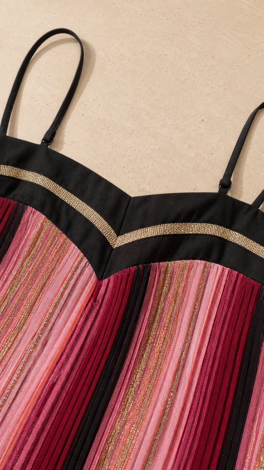 Close-up detail of the bodice, straps, and pleated fabric texture