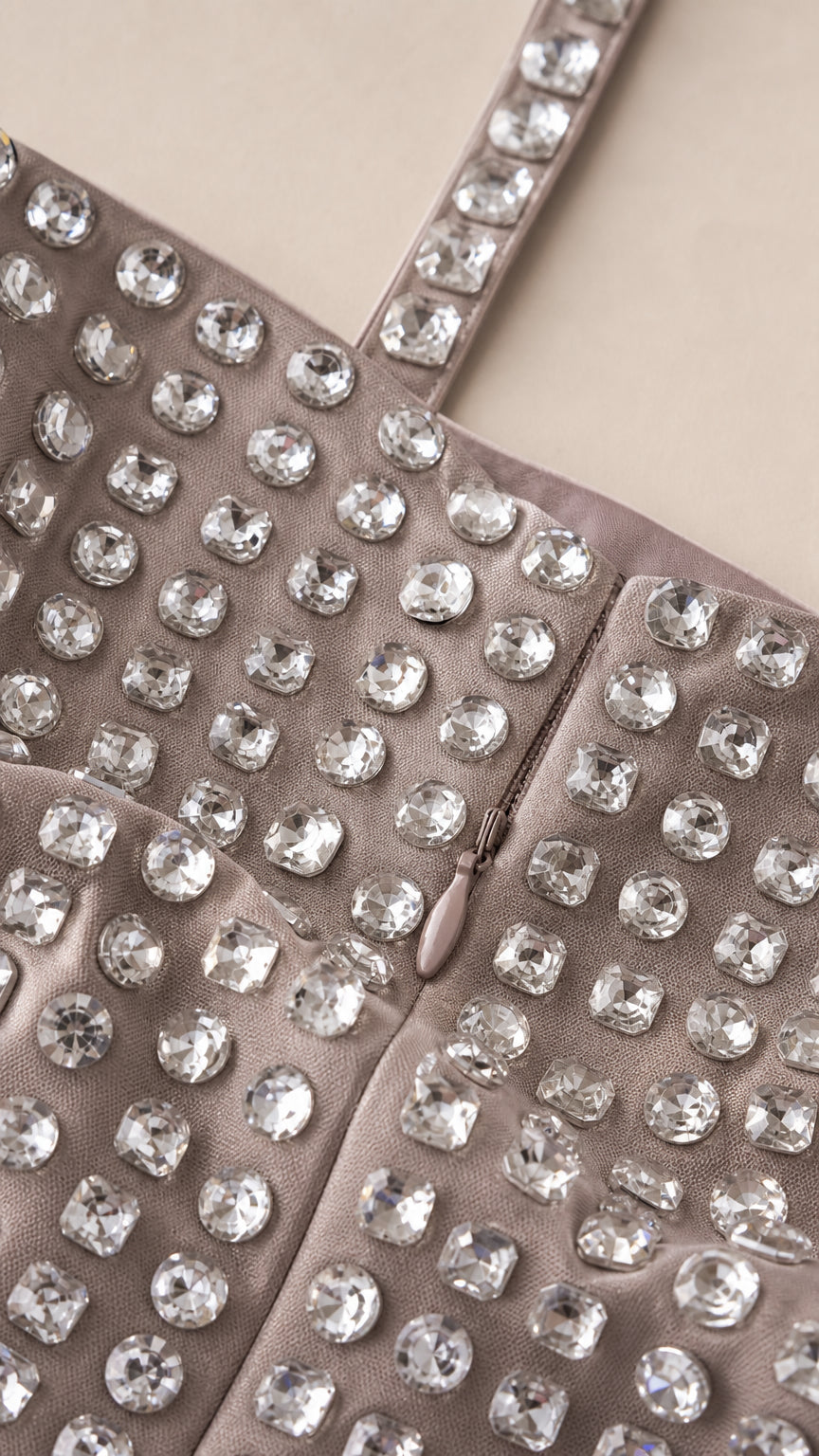 Close-up detail of sparkling rhinestone embellishments and hidden zipper construction