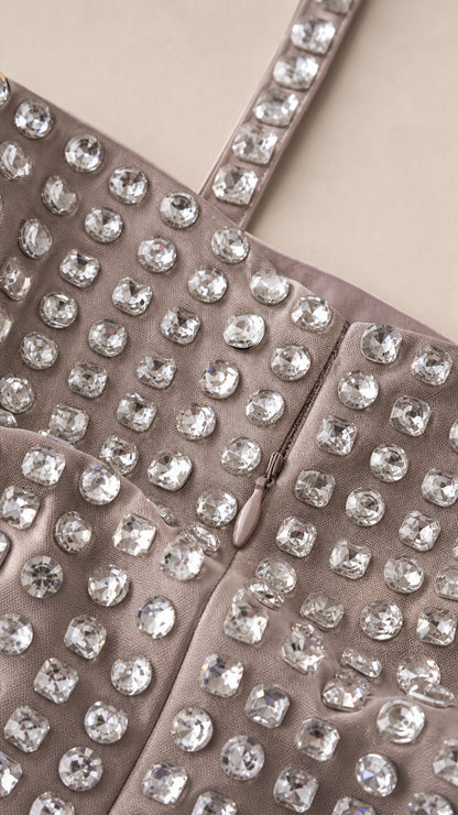 Close-up detail of sparkling rhinestone embellishments and hidden zipper construction