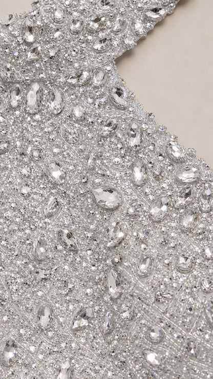 Close-up detail of intricate silver sequins and sparkling crystal embellishments