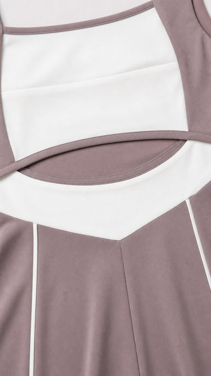 Close-up detail of cutout waist, contrast white band, and piping on dusty mauve jumpsuit