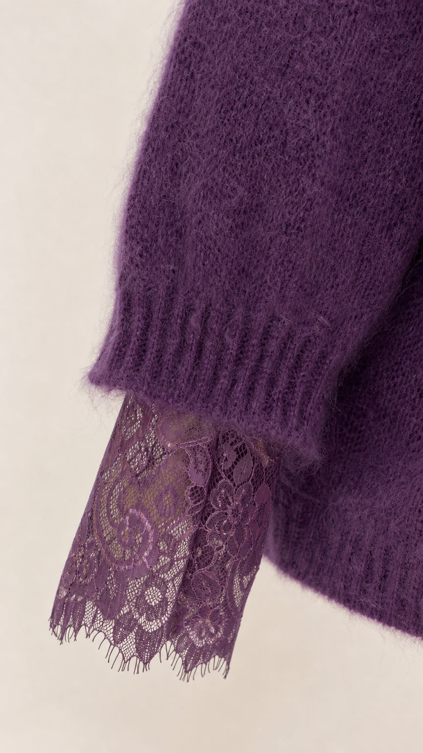 Close up of purple fuzzy knit sleeve with floral lace cuff detail