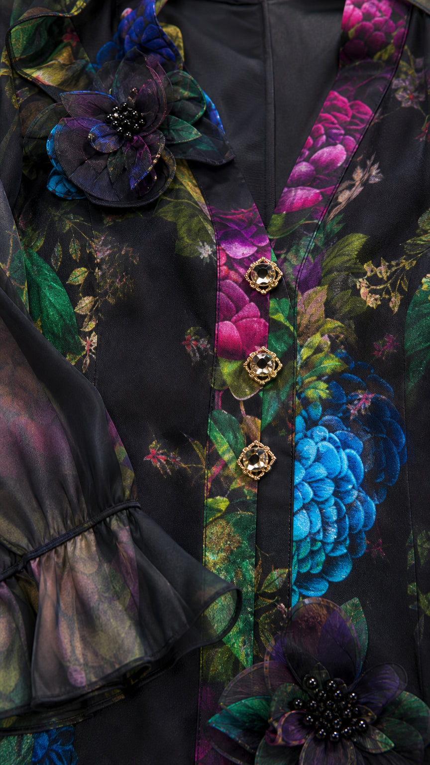 Close-up detail of 3D flower applique, jewel buttons, and sheer ruffled cuff