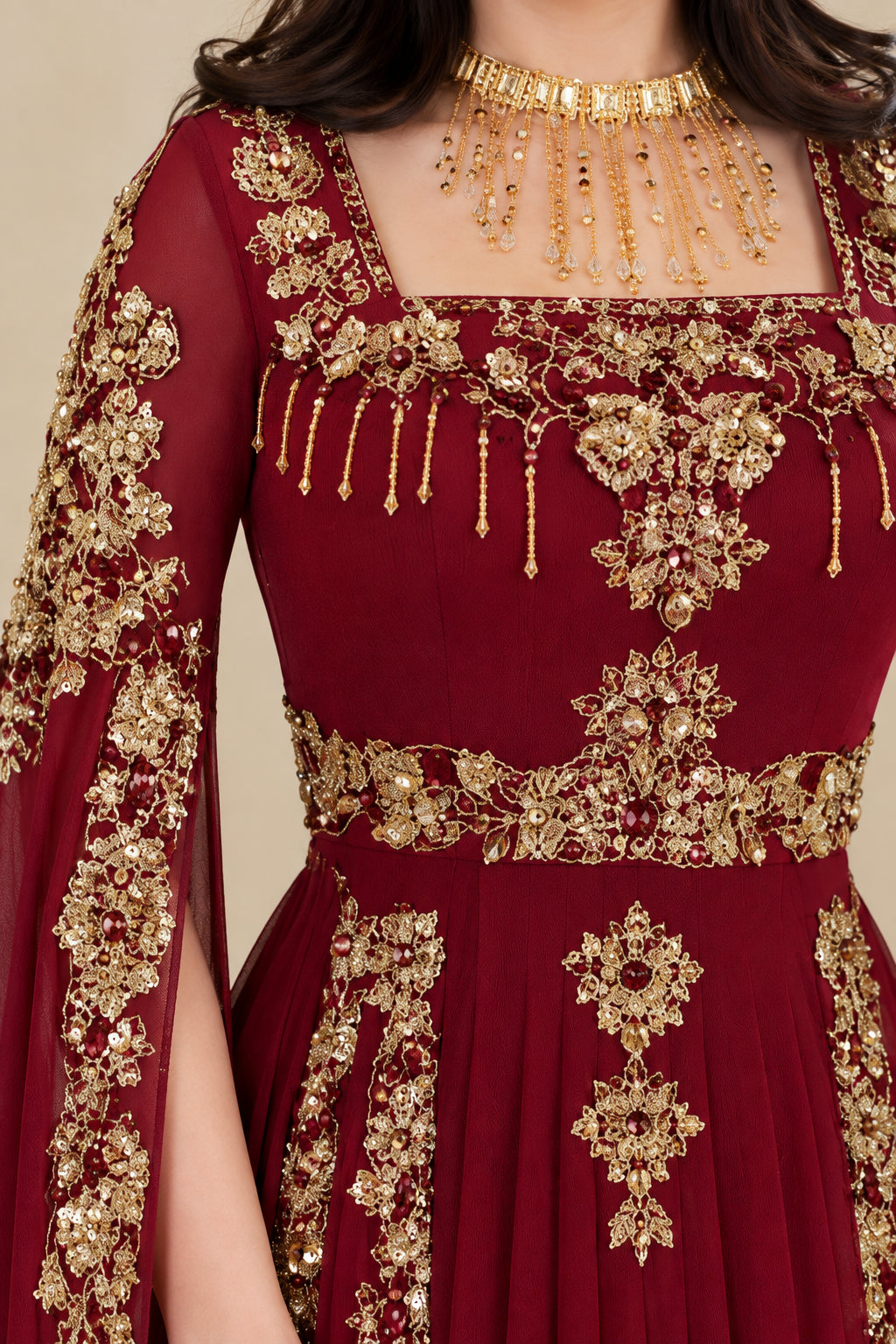 Close-up of gold beaded neckline and bodice embroidery on burgundy gown
