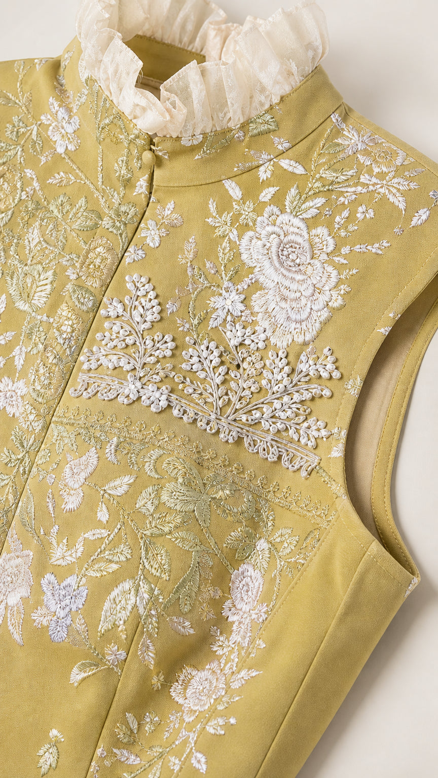 Close up of bodice embroidery and ruffled collar