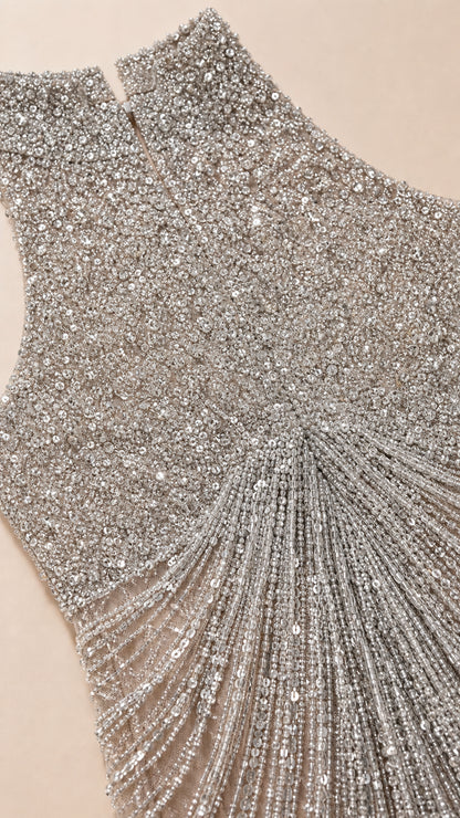 Close up detail of intricate silver sequin and beaded fringe craftsmanship