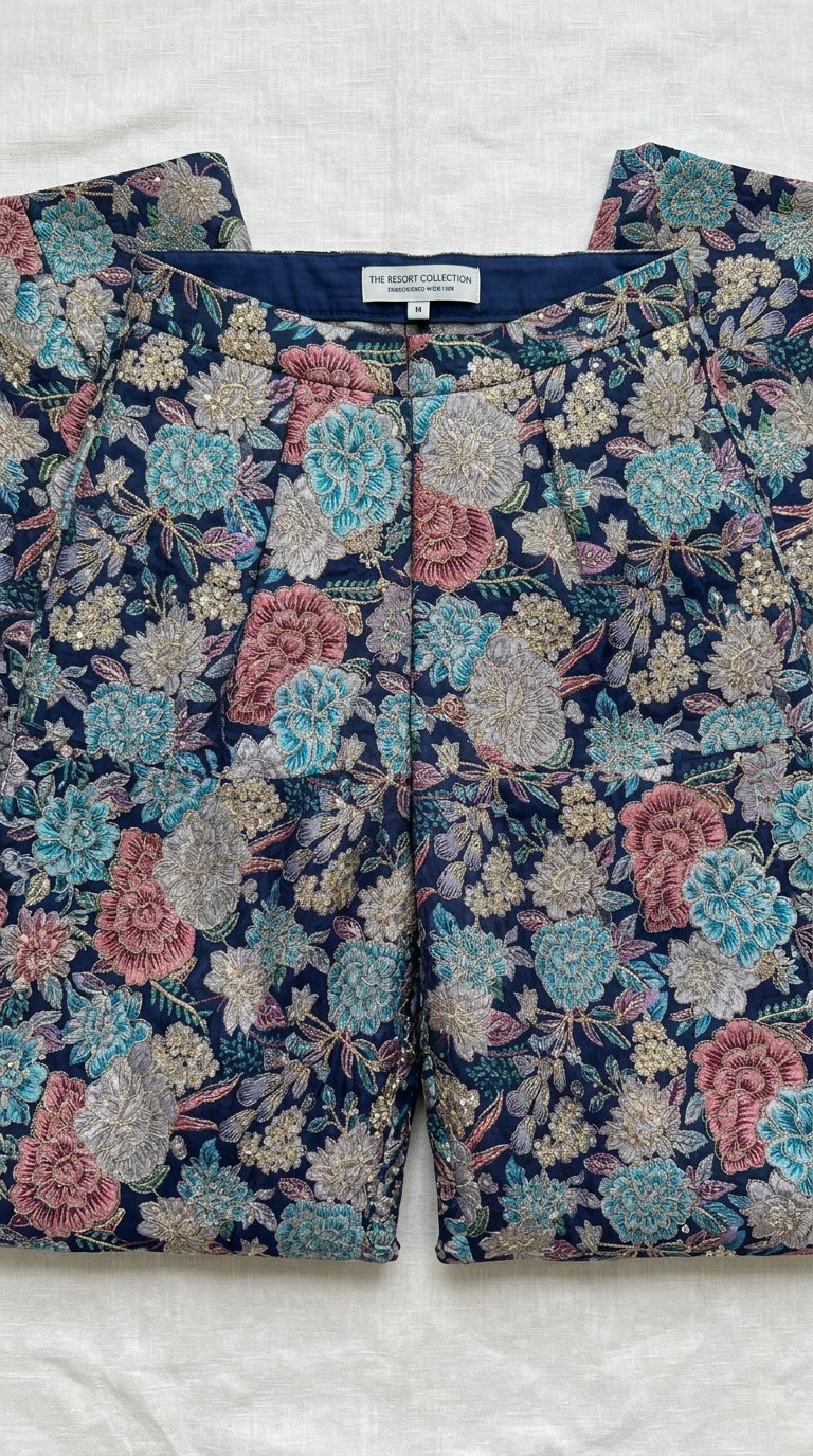 Close-up flat lay of floral print trouser waistband and intricate pattern details
