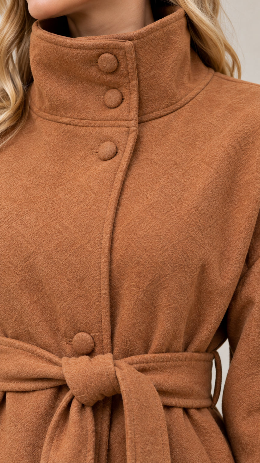 Close up of high stand collar and covered button details on camel coat