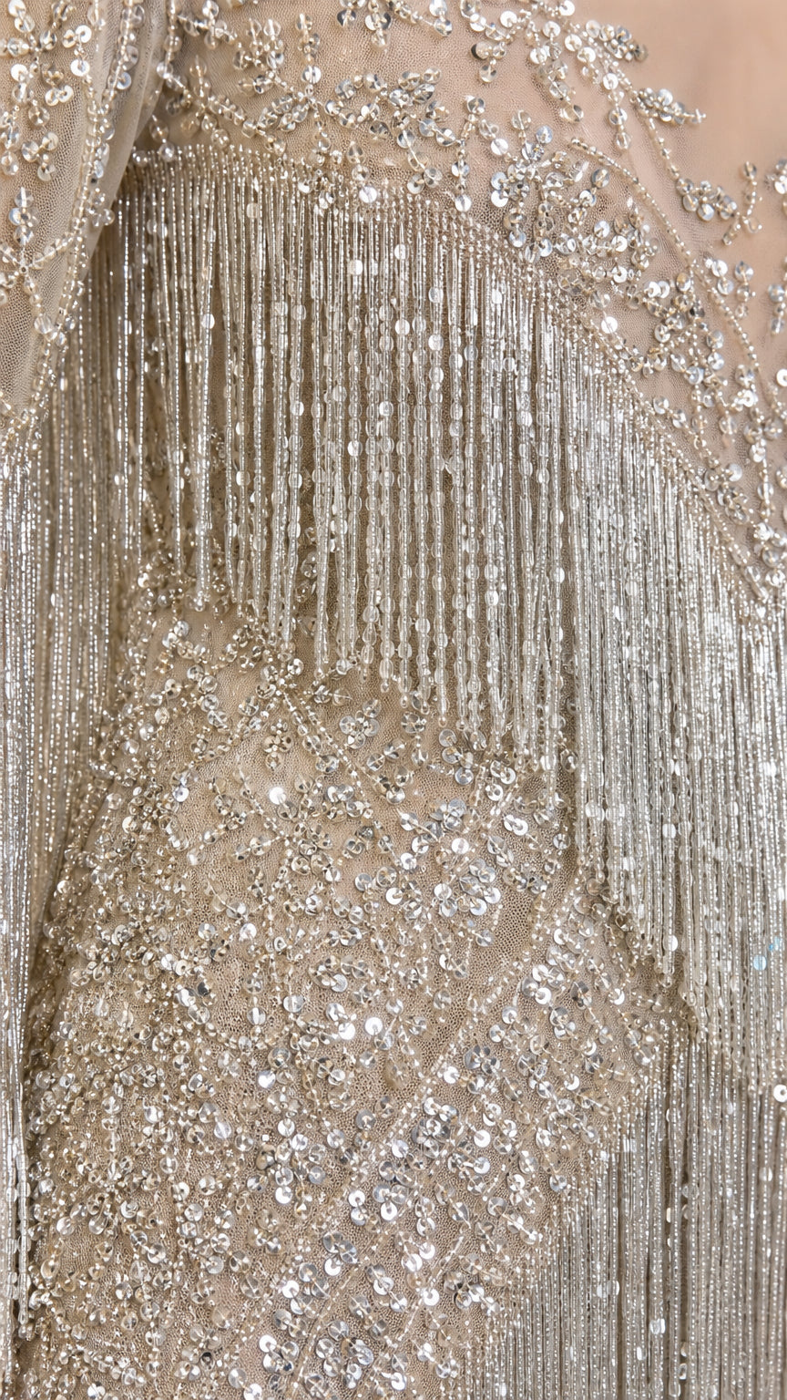 Close-up detail of shimmering silver sequins and tiered beaded fringe