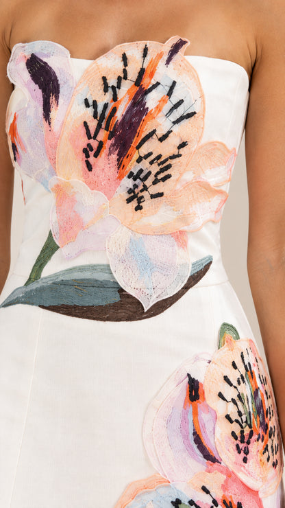 Close up detail of colorful floral embroidery on strapless bodice
