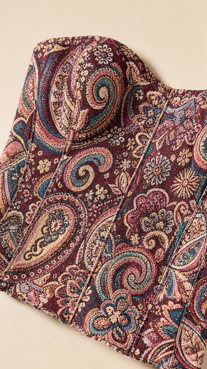 Close up view of Burgundy paisley jacquard tapestry fabric and structured bustier cups