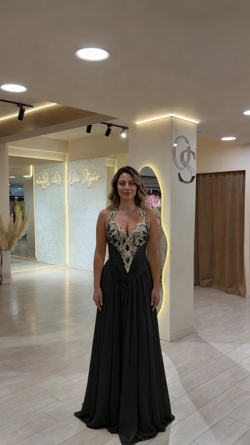 Model wearing classic black beaded halter neckline evening gown