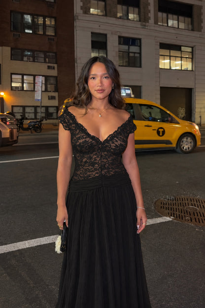 Woman wearing black lace V-neck formal maxi gown