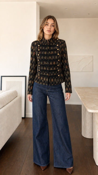 Front view of model wearing Black geometric woven military jacket with gold buttons