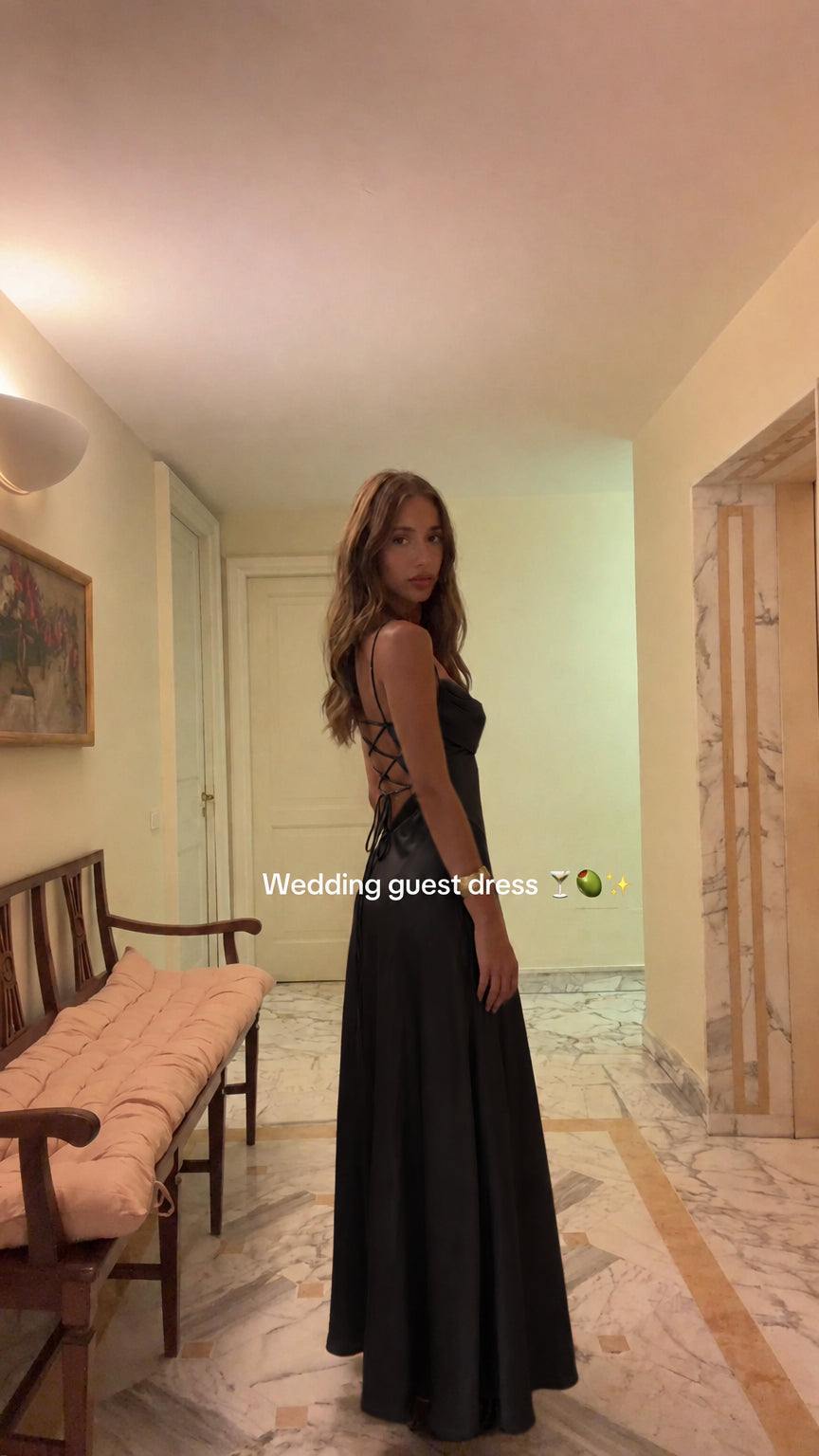 Model wearing Black satin cowl neck open back maxi dress