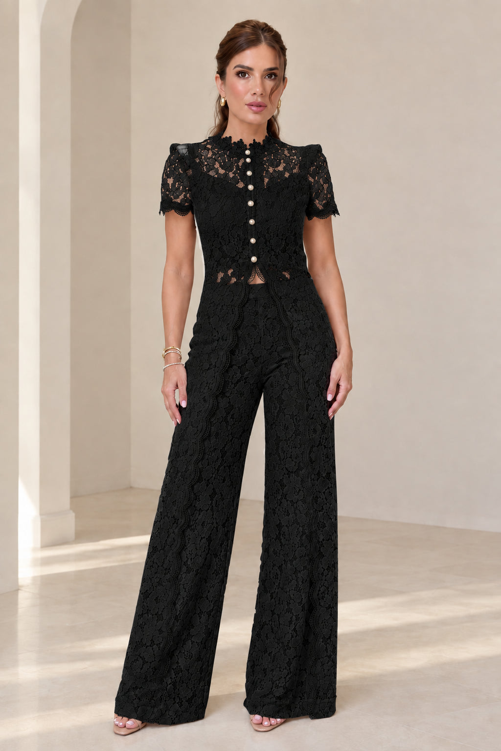 Model wearing black floral lace two-piece top and wide-leg pant set
