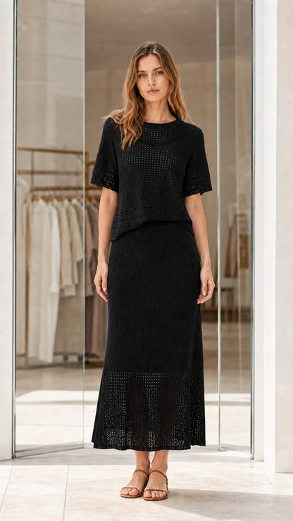Full front view of black knit two-piece short sleeve top and maxi skirt set