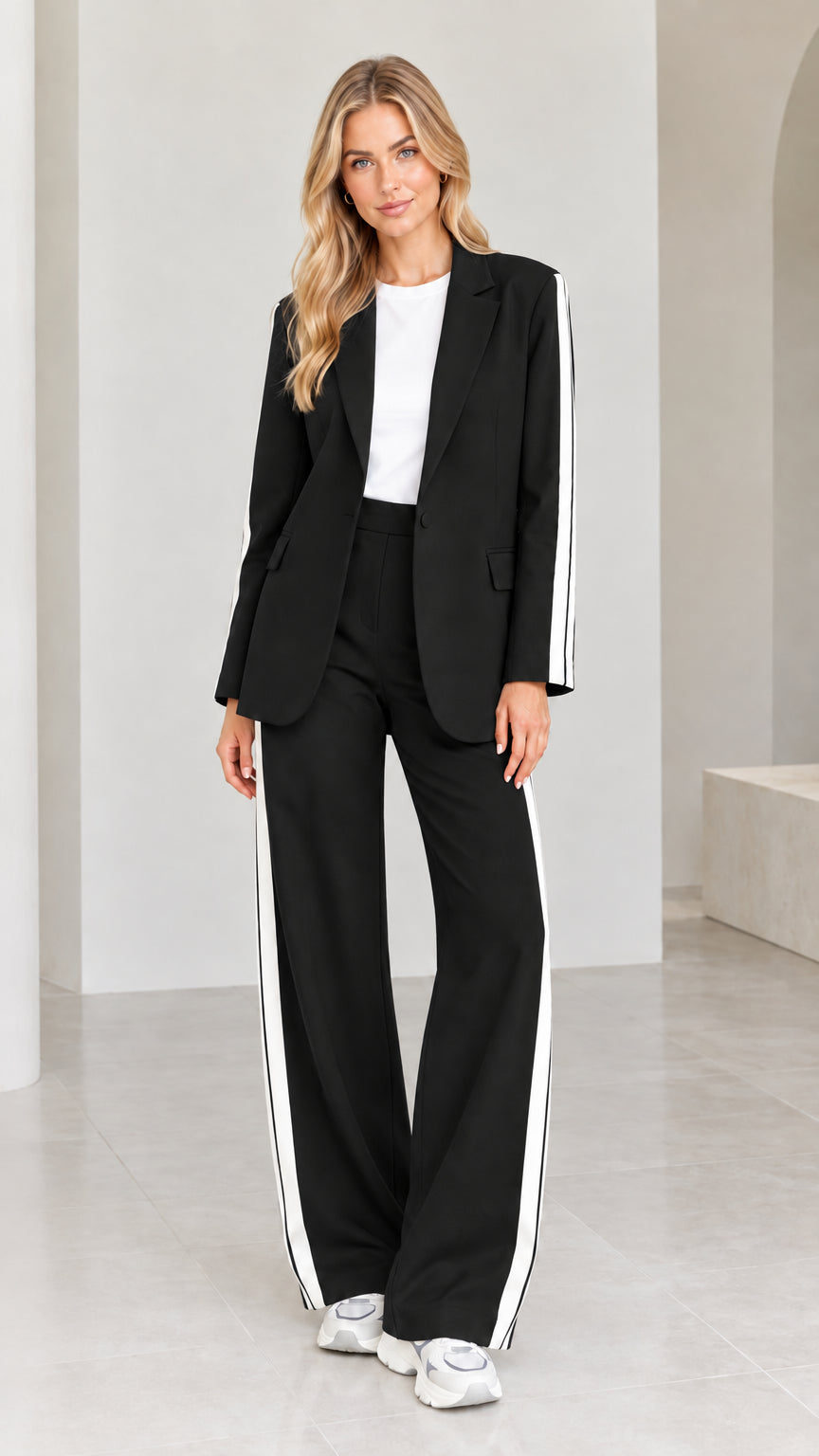 Model wearing black 2-piece blazer and wide-leg pants suit set with white side stripes