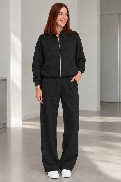 Woman wearing Black collared zip-up jacket and wide-leg lounge set