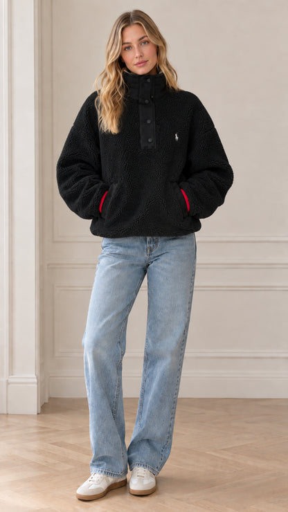 Front view of model wearing black sherpa fleece snap-neck pullover