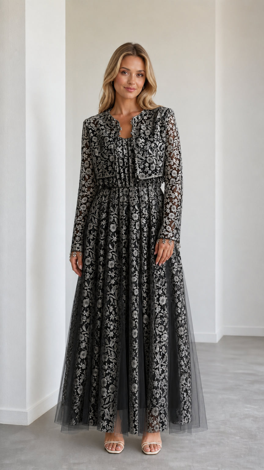 Model wearing black floral lace maxi dress with matching cropped jacket