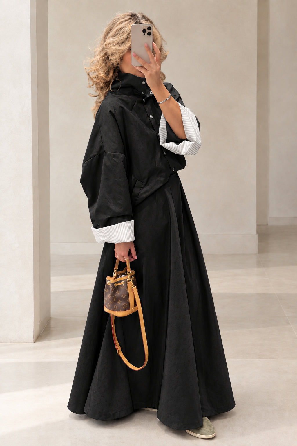 Full-length view of woman wearing Black jacket and maxi skirt two-piece set