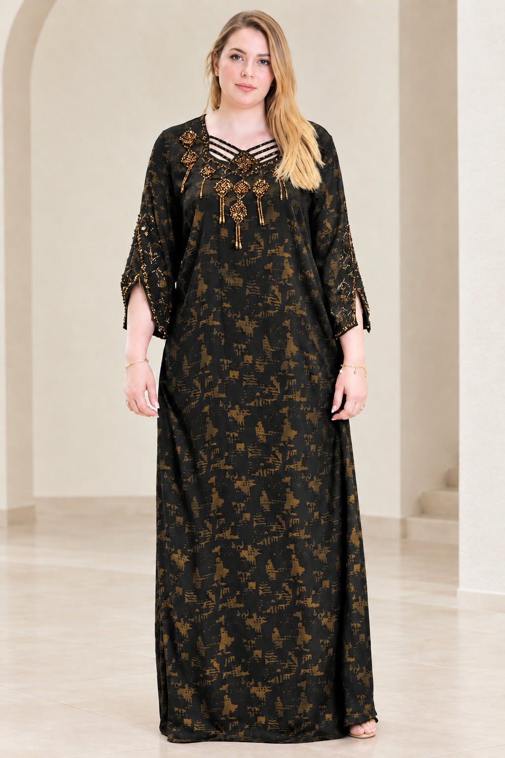 Front view of woman wearing black beaded strappy neckline kaftan dress
