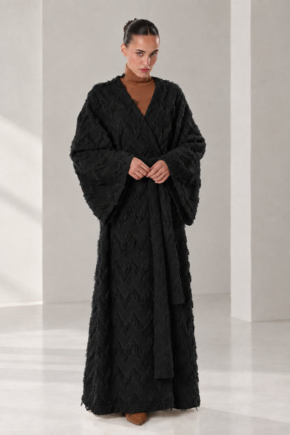 Front full view of woman wearing black textured chevron fringe maxi wrap robe