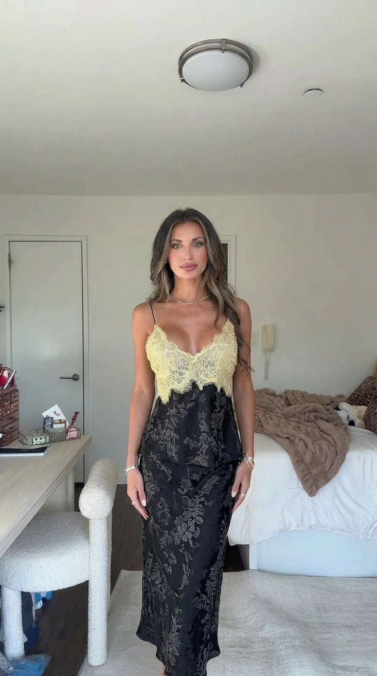 Front view of model wearing the black jacquard lace camisole and midi skirt set