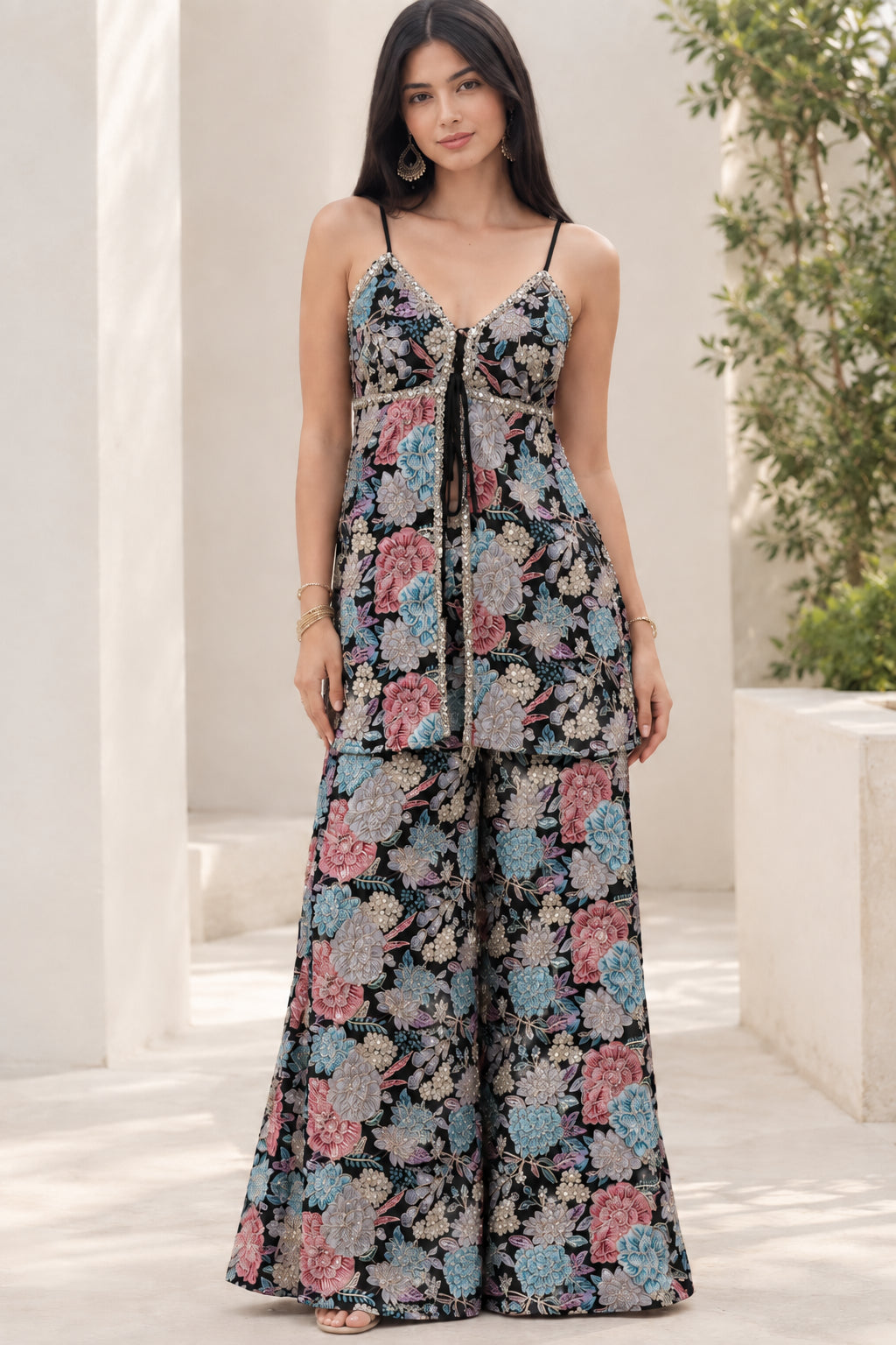 Model wearing Black floral print sleeveless tunic top and wide-leg palazzo pants set