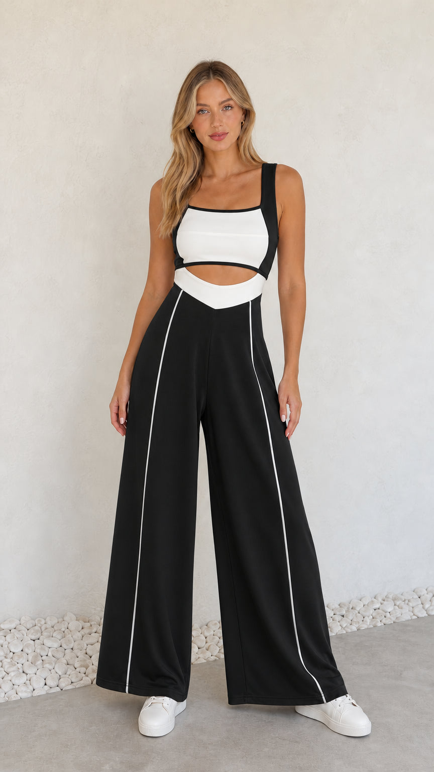 Model wearing black colorblock cutout wide-leg jumpsuit with white piping